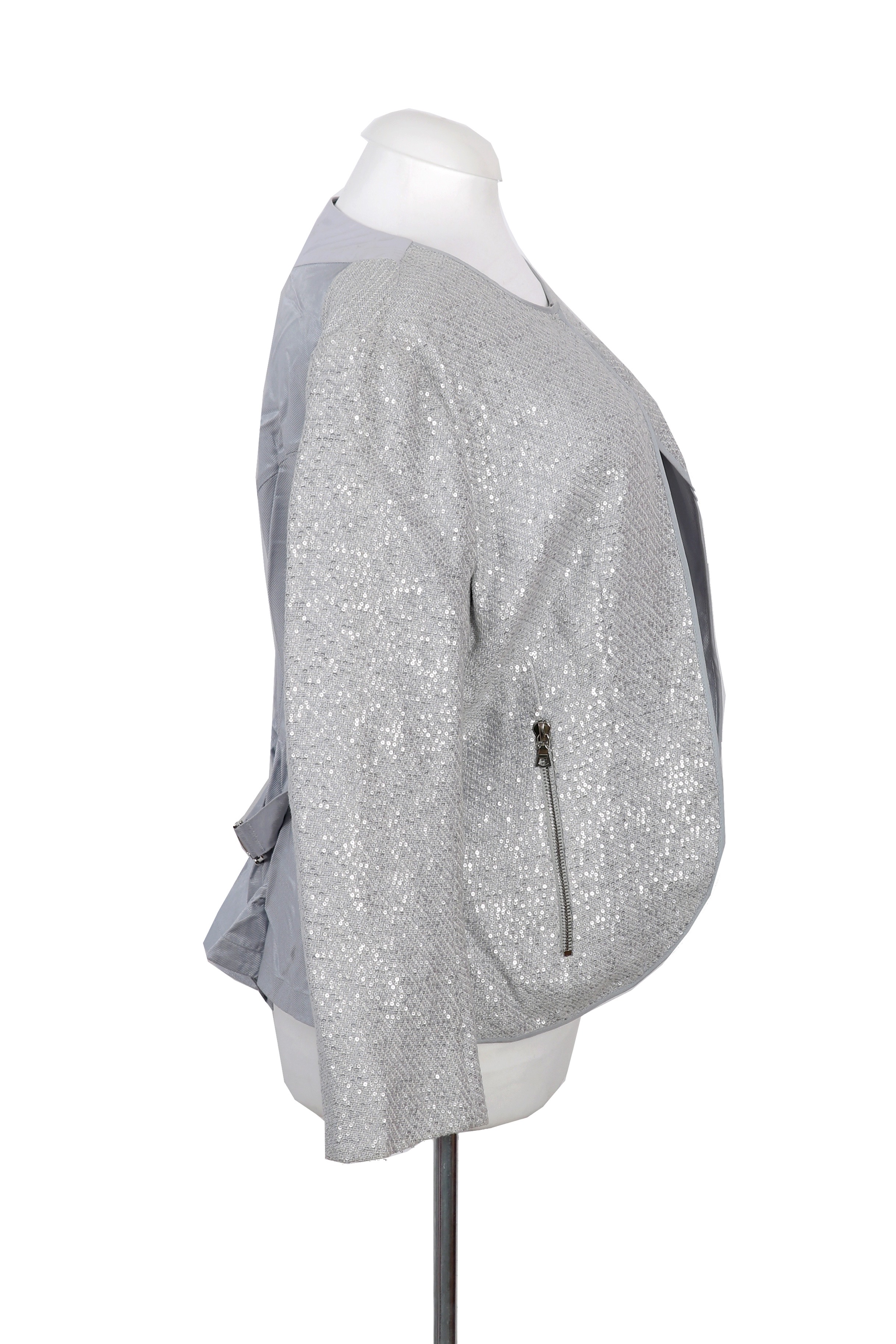 An elegant Nina Ricci jacket in shimmering silver, tailored with a sleek open-front design