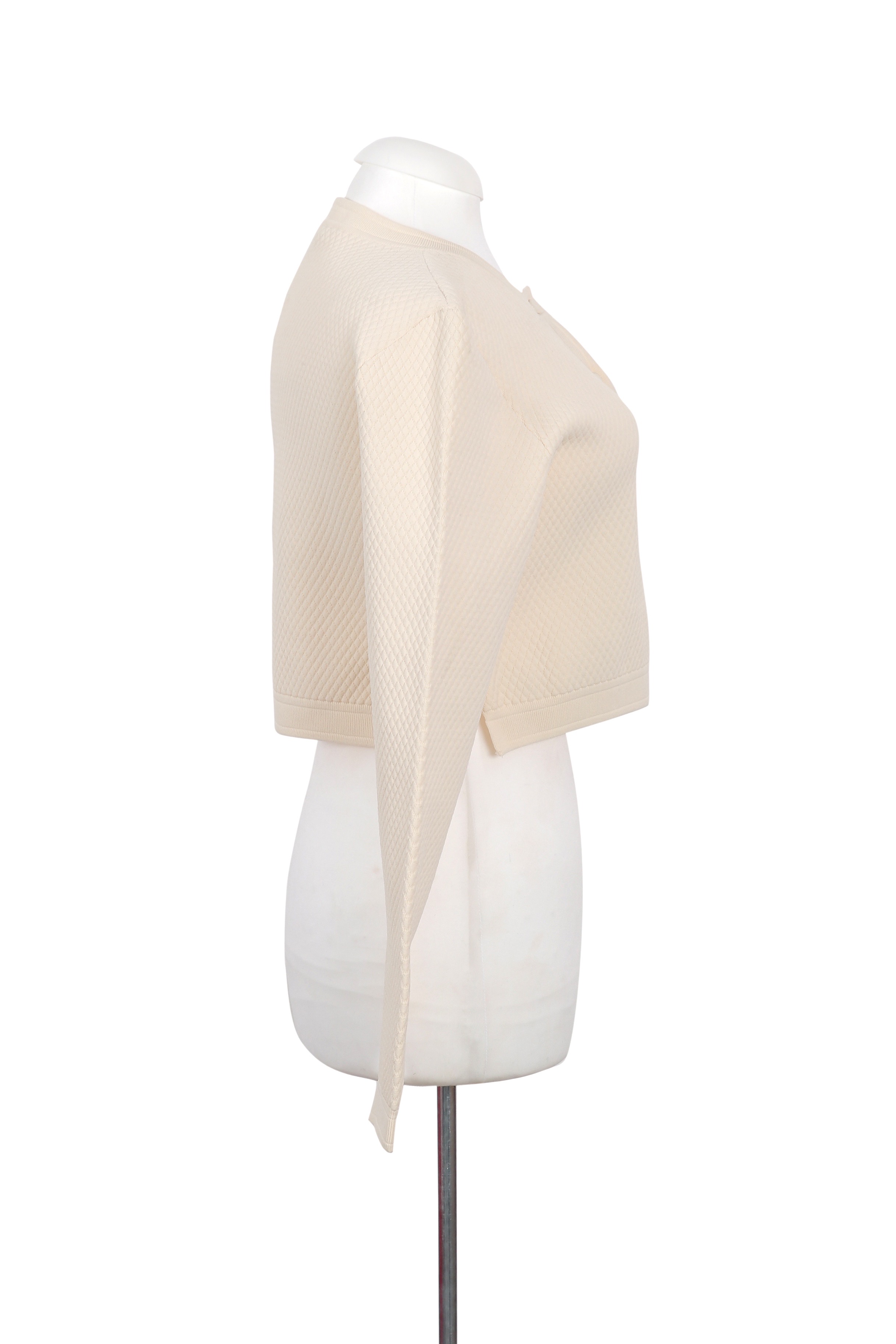 A refined Gucci cream cardigan with a cropped silhouette, crafted in textured knit for a chic and versatile look