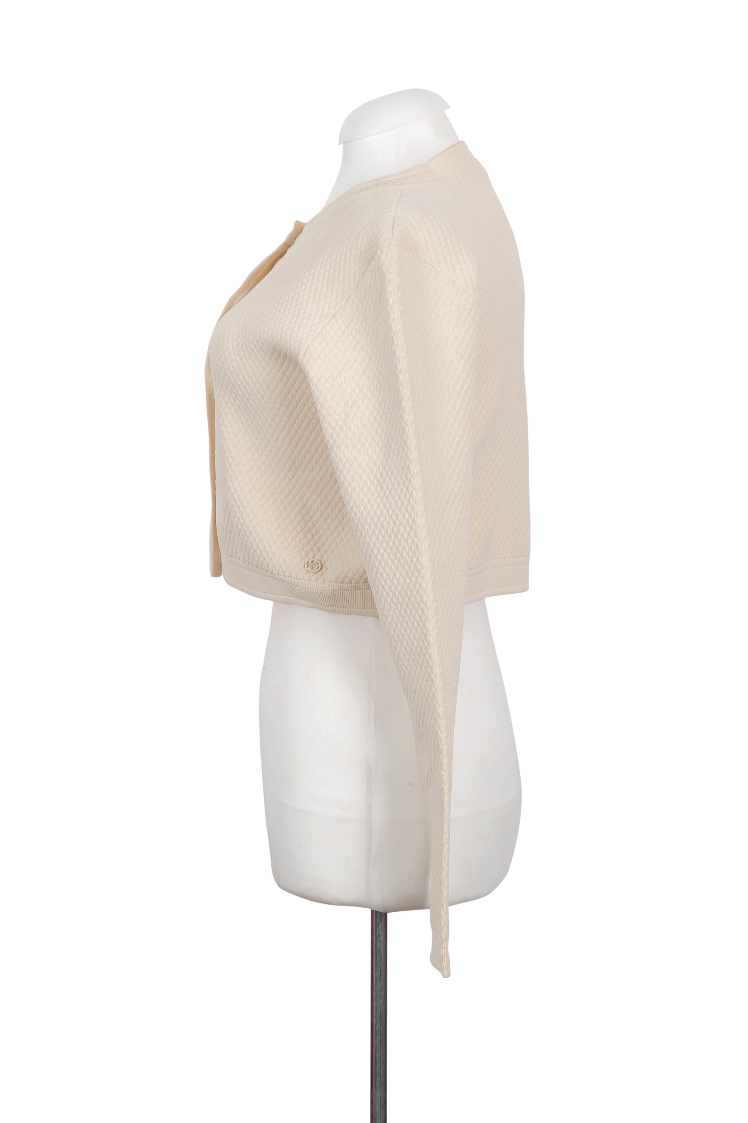 A refined Gucci cream cardigan with a cropped silhouette, crafted in textured knit for a chic and versatile look