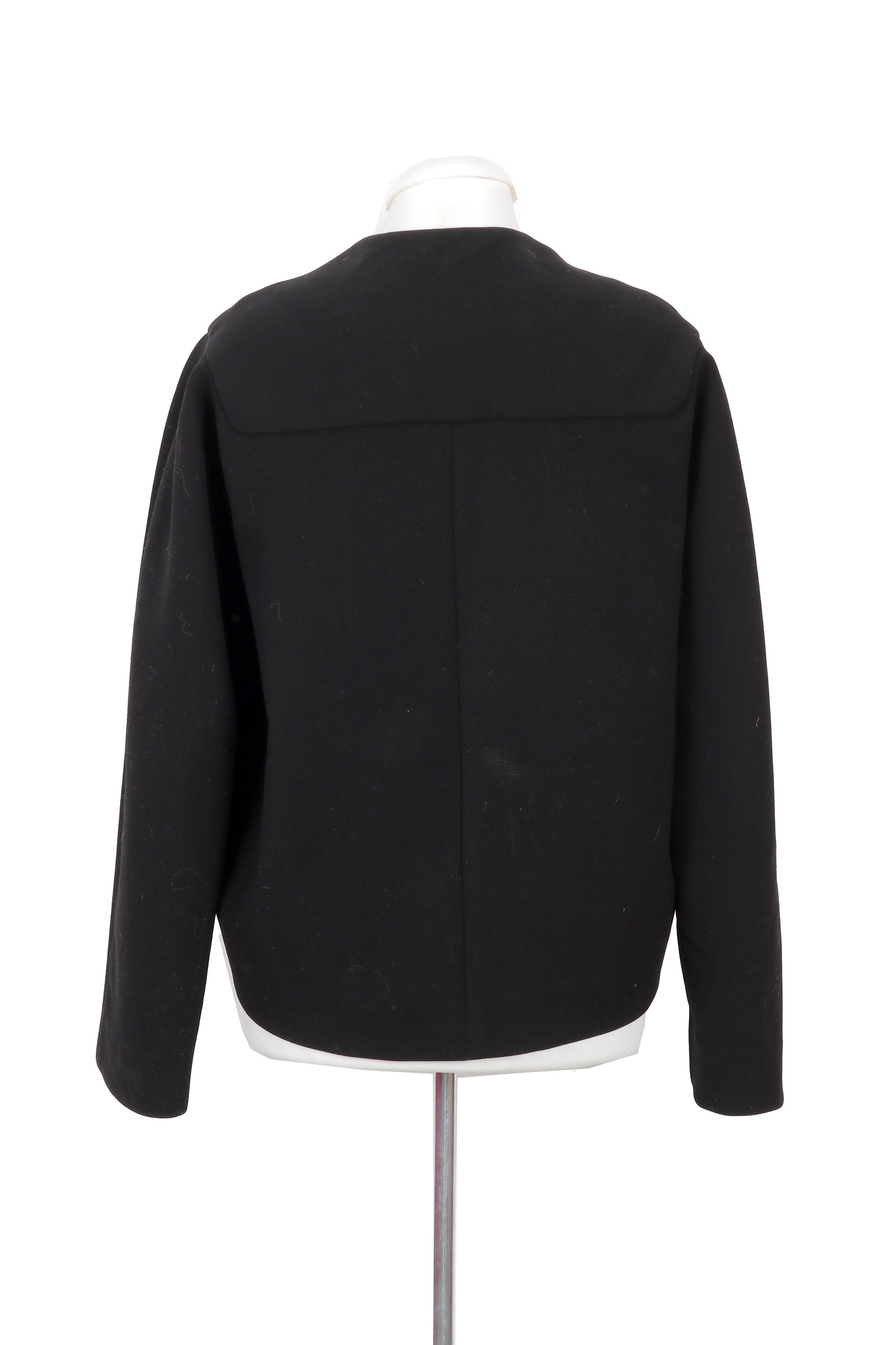 Balenciaga structured black jacket featuring a minimalist silhouette with sleek metal bar closures, offering a refined and modern look